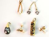 several different types of earrings and pendants on a white surface