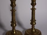 pair of antique brass candlesticks on a white background