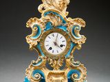a blue and gold clock sitting on top of a table