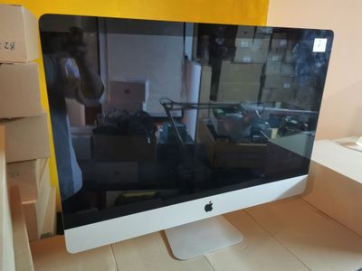 a computer monitor sitting on a desk in a room