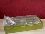 a plastic spoon and fork in a green box on a table