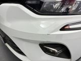 the front end of a white sports car with a black bumper
