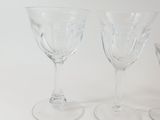 three wine glasses sitting next to each other on a table