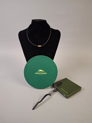 a green box with a necklace and a book on a table