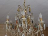 a crystal chandelier hanging from the ceiling in a room