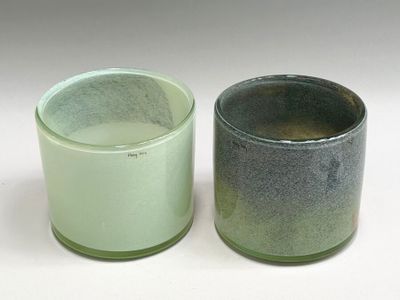 two cups sitting next to each other on a white surface