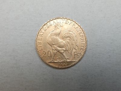 a close up of a gold coin with a rooster on it