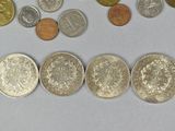 a lot of coins that are on the table