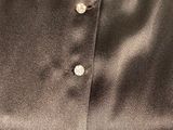 a close up of a black shirt with buttons on it