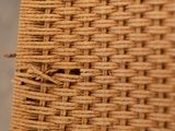 close up of a wicker chair with a hole in the back