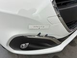 a close up of a white car with a sticker on it ' s bumper