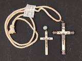 two crosses and a rope on a black surface