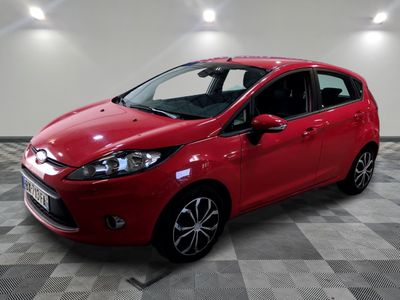 a red ford fiesta parked on a checkered floor