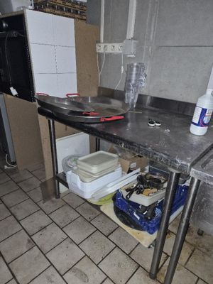 a kitchen with a table and a stove in it
