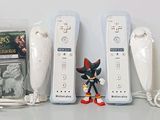 a lot of video game remotes sitting on a table