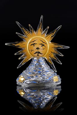 crystal sun with face on top of a crystal pyramid on a reflective surface