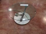 a glass table with a metal object on top of it