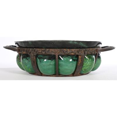 a close up of a green bowl on a white surface