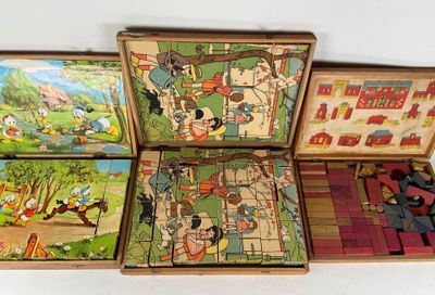 three wooden puzzles in a box with pictures of people and animals