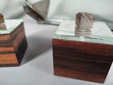 two wooden boxes with a glass top on a table