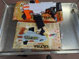 a toy gun and a toy gun on top of a cart