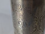 a silver cup that is sitting on a table