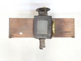 a wooden beam with a clock mounted to it ' s side