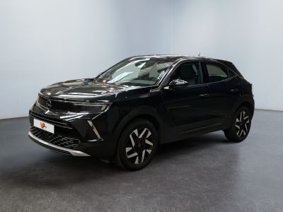 a black suv is parked in a room with a white wall