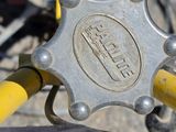a close up of a bike handle with a yellow handlebar