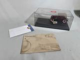 a small model of a car in a glass case