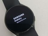 the samsung smart watch is sitting on a table with a white background