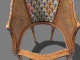 an antique wicker chair with a floral upholstered seat