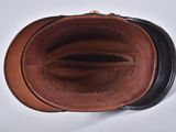 a brown and black purse sitting on top of a white table