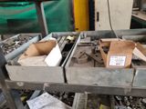 many boxes of tools sitting on a table in a factory