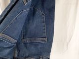 jeans hanging on a hanger on a white sheet with a white background