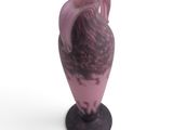a purple vase with a bird on it on a white surface