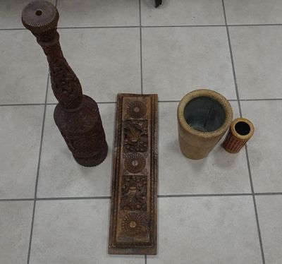 two vases and a pipe on the floor next to each other