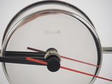a clock with a red second hand and a black second hand