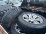 tires in the back of a pick up truck in a parking lot