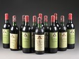 six bottles of wine are lined up in a row on a table