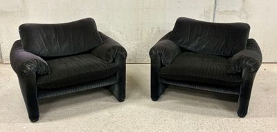 pair of black leather club chairs with arms and legs
