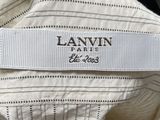 the label is on the back of a white shirt with black and white stripes