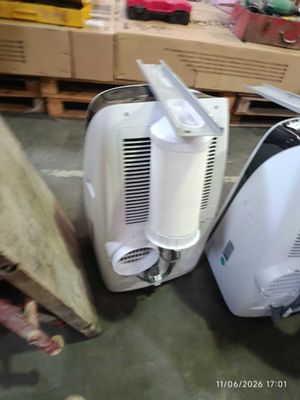 two white appliances sitting next to each other on the floor