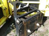 a black and yellow bulldozer sitting on the ground next to a yellow bulldozer