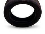 a tire that is sitting on a white surface
