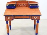 a small wooden desk with a blue drawer on top of it