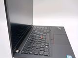the laptop is open on a white surface with a black keyboard