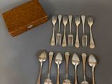 a lot of forks and spoons that are on the table