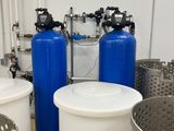 three blue tanks and a white container in the middle of a room