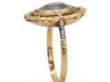 a close up of a gold ring with a stone in it